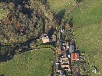 Oblique aerial view centred on the tower house with the farmstead adjacent, taken from the SSE.