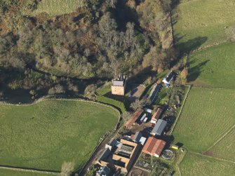 Oblique aerial view centred on the tower house with the farmstead adjacent, taken from the SE.