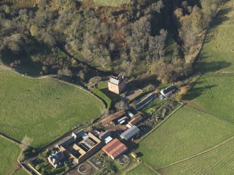 Oblique aerial view centred on the tower house with the farmstead adjacent, taken from the SE.