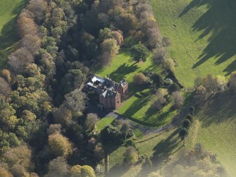 Oblique aerial view centred on the tower house/country house, taken from the NNW.
