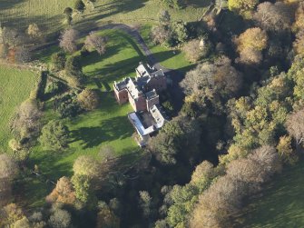 Oblique aerial view centred on the tower house/country house, taken from the ESE.
