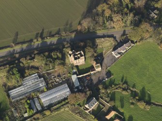 Oblique aerial view centred on the country/tower house, taken from the, taken from the SW.