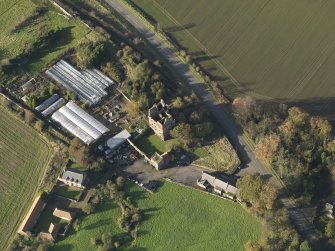 Oblique aerial view centred on the country/tower house, taken from the, taken from the SE.