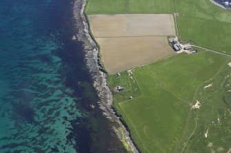 Oblique aerial view of the remains of the West  Broch of Burray and the Northfield Battery , taken from the W.