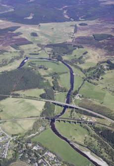 General oblique aerial view looking down the River Finhorn at Tomatin with the A9 bridge and railway viaduct in the foreground, taken from the SW.