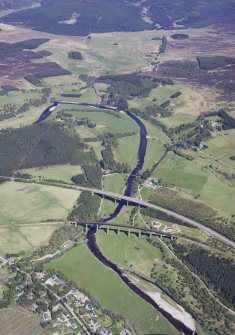 General oblique aerial view looking down the River Finhorn at Tomatin with the A9 bridge and railway viaduct in the foreground, taken from the SW.