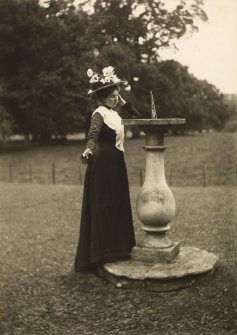 View of woman next to a sundial, possibly at Lennoxlove House


