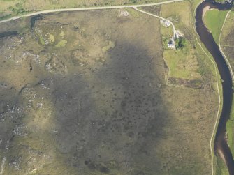 Oblique aerial view centred on the remains of the hut circle, taken from the S.