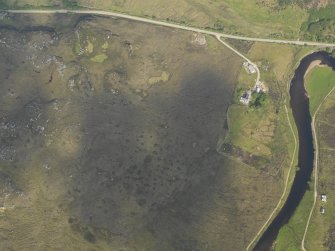 Oblique aerial view centred on the remains of the hut circle, taken from the SE.