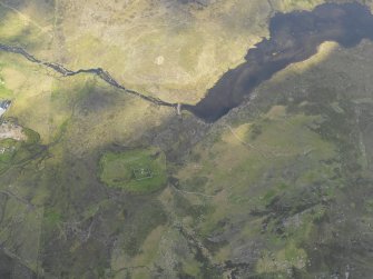 General oblique aerial view centred on the possible hut circle, and the field systems. Taken from the N.