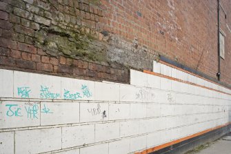 NW side brick and tilework. Detail