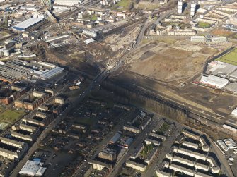 Oblique aerial view of the M74 extension going through the Polamadie area to the M74 centred on Gushetfaulds railway junction, taken from the SSE.
