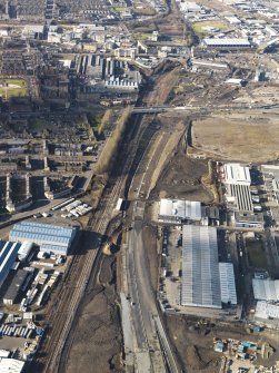Oblique aerial view of the M74 extension going through the Polamadie area to the M74 centred on Gushetfaulds railway junction, taken from the SE.