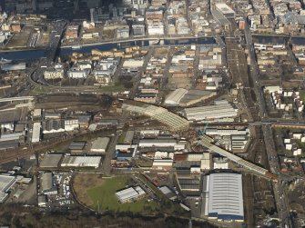 Oblique aerial view of the city centre showing M74 extension going through the Port Eglinton area to the M74 centred on the Eglinton Street goods station, taken from the S.