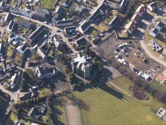 Oblique aerial view centred on the church, taken from the NNE.