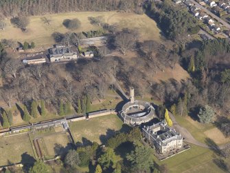 Oblique aerial view centred on the country house with the stable block adjacent, taken from the SSW.