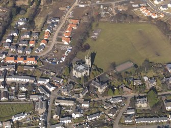 General oblique aerial view centred on the church, taken from the SE.