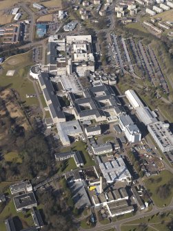 Oblique aerial view centred on the hospital, taken from the ESE.