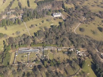 Oblique aerial view centred on the walled garden with the country house adjacent, taken from the  S.