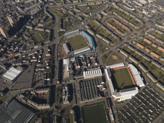 Oblique aerial view centred on the football stadia, taken from the E.