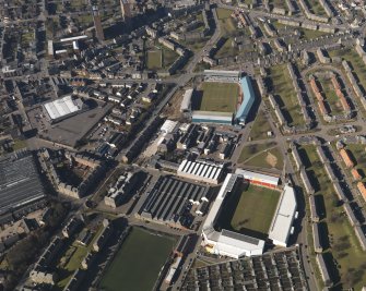 Oblique aerial view centred on the football stadia, taken from the ENE.