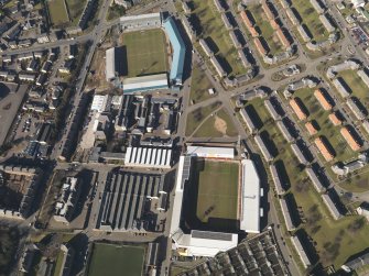 Oblique aerial view centred on the football stadia, taken from the E.