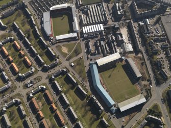 Oblique aerial view centred on the football stadia, taken from the WNW.