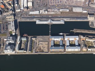 General oblique aerial view centred on the dock area, taken from the SE.