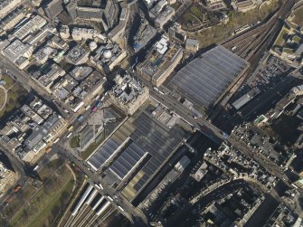 Oblique aerial view centred on the railway station, taken from the SW.