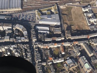 General oblique aerial view centred on the High Street and Canongate, taken from the SSE.