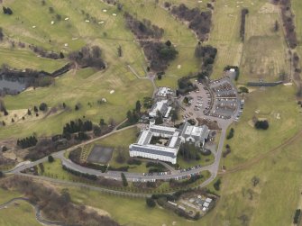 Oblique aerial view centred on the country house with the country club adjacent, taken from the NNW.