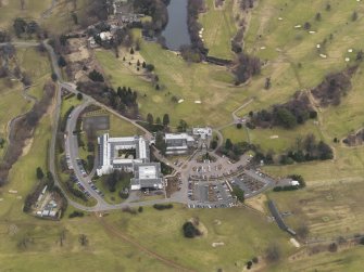 Oblique aerial view centred on the country house with the country club adjacent, taken from the WSW.