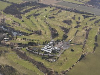 General oblique aerial view centred on the country house with the country club adjacent, taken from the NW.