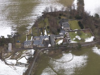 Oblique aerial view centred on the house, taken from the W.