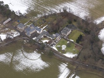 Oblique aerial view centred on the house, taken from the SW.