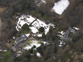Oblique aerial view centred on the house, taken from the SSE.