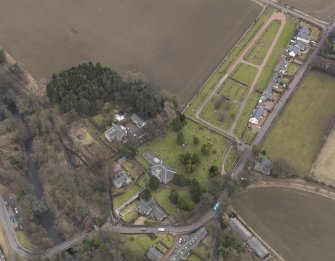 Oblique aerial view centred on the kirk with the burial ground adjacent, taken from the NW.