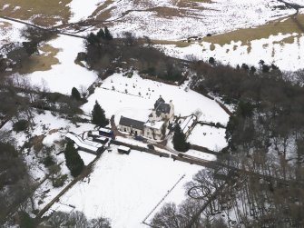 Oblique aerial view centred on the fortified house, taken from the NW.