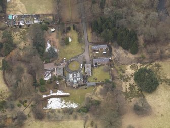 Oblique aerial view centred on the country house with the stable block, taken from the SSE.