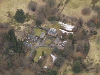 Oblique aerial view centred on the country house with the stable block, taken from the NW.