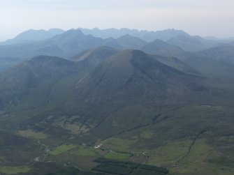 General oblique aerial view looking across Beinn na Caillich and Blabheinn towards the Cuillins, taken from the NE.
