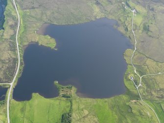 General oblique aerial view of Loch Mealt centred on Dun Grianan broch, taken from the NNW.
