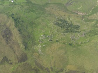 Oblique aerial view of the remains of the buildings and field banks, taken from the SSE.