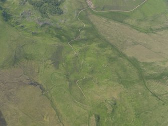 Oblique aerial view of the remains of the buildings and field banks, taken from the ESE.