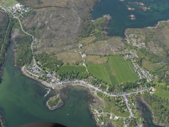 Oblique aerial view centred on Plockton village with the fish traps and kelp grid adjacent, taken from the E.