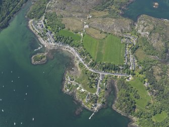 Oblique aerial view centred on Plockton village with the fish trap and kelp grid adjacent, taken from the E.