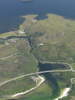 Oblique aerial view looking along the River Morar across the bridges, taken from the W.