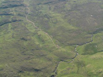 Oblique aerial view of the remains of the field system and buildings, taken from the SW.