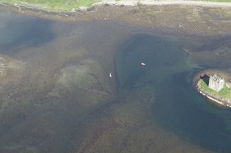 Oblique aerial view of the shallow water beside Castle Stalker, taken from the WNW.