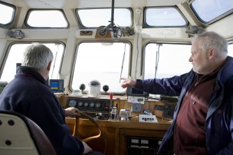 En route to the island, boat owner Bill Simpson and RCAHMS field surveyor David Easton.